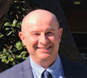 Photo of Craig Cashmore. Photo shows just the head of a Caucasian man, with no hair. The man is smiling.