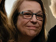 Photo of Diane P. Wormsley. Photo shows just the head of a Caucasian woman, with light brown hair of below shoulder length. The woman is wearing blue framed glasses and is smiling.